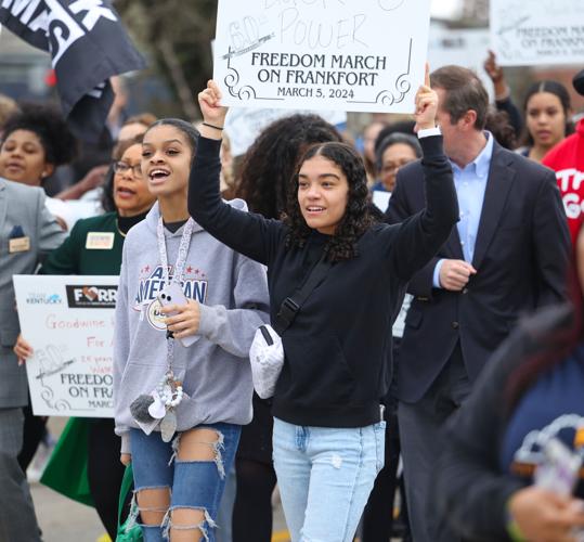 Girl holds up sign during March on Frankfort.JPG