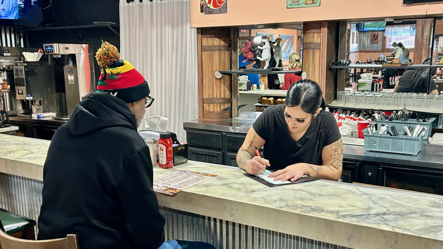 Server takes customer's order at Crystal's Country Diner South