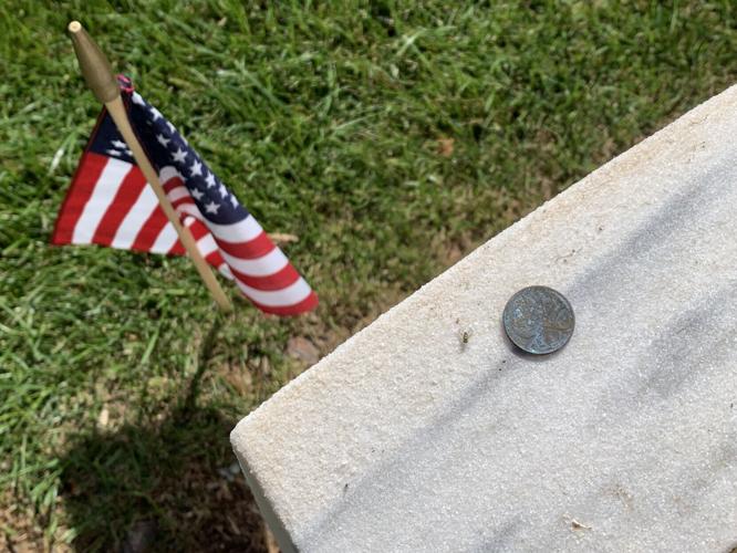 Placing pennies on Memorial Day at Zachary Taylor Cemetery