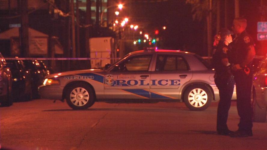 LMPD vehicle in front of crime scene tape at night