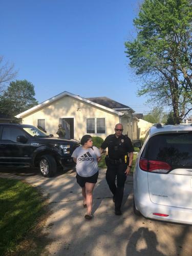 Alexus Bush escorted to patrol car.jpg