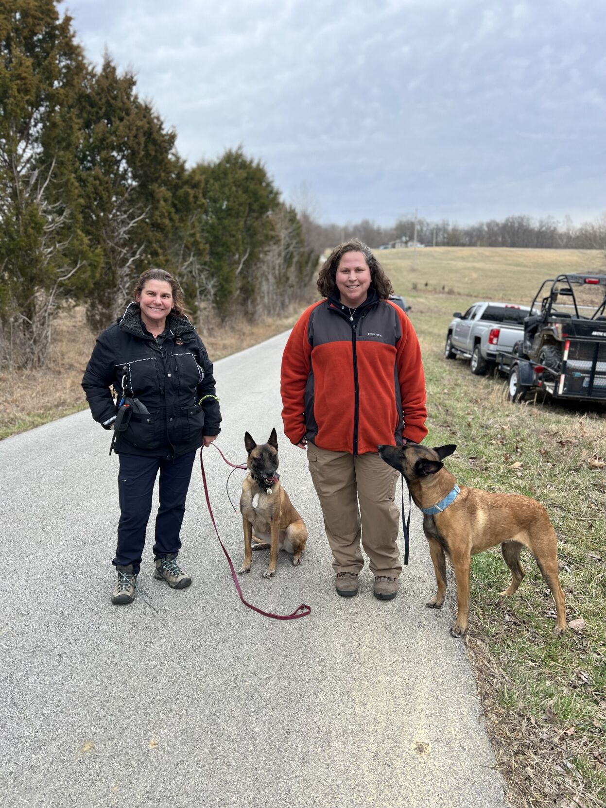 Two police K-9s and their handlers taking part in a search for a missing woman in Caneyville, Kentucky