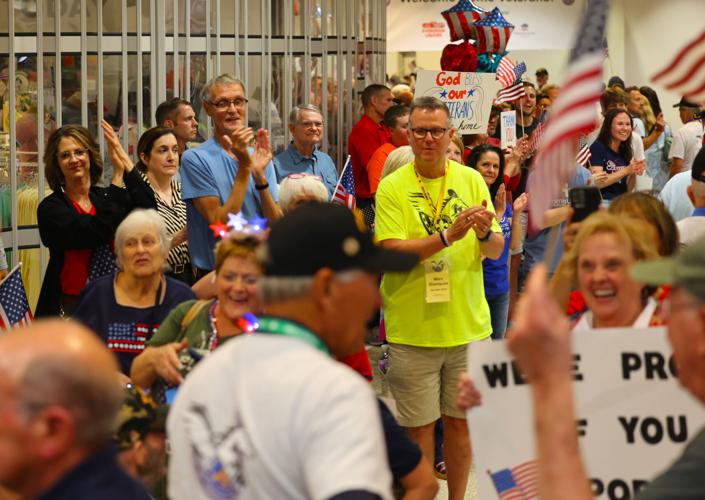 People cheer at the end of Honor Flight Return Home.JPG