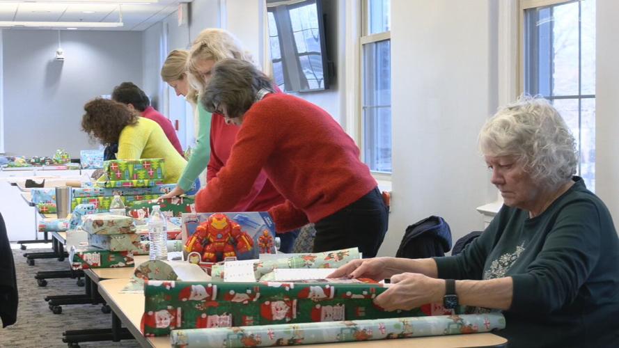 Volunteers wrap presents at Kosair Charities in Louisville