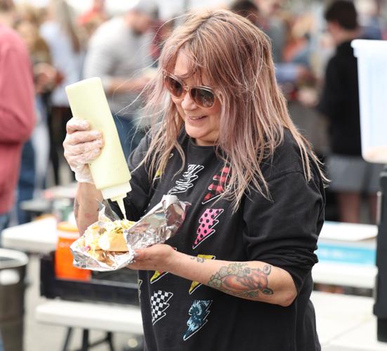 Vendor prepares hot dog
