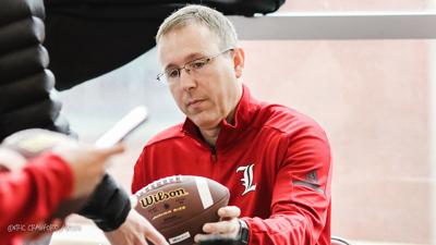 Satterfield signs footballs