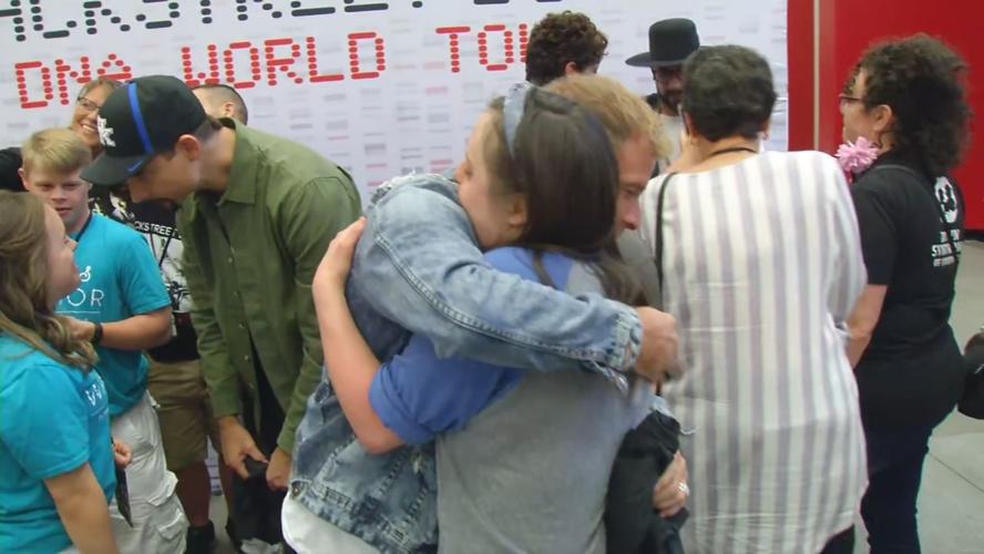 Brian Littrell of the Backstreet Boys hugs a member of Down Syndrome of Louisville