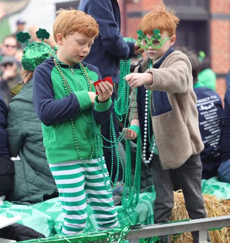 Boys toss out beads at parade