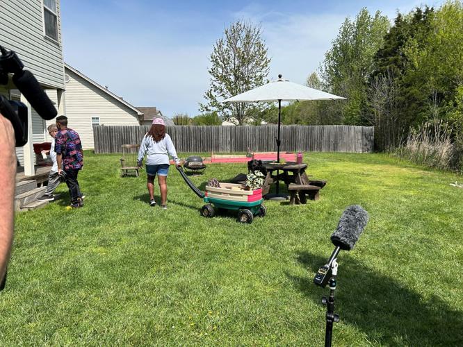 Torrie Carver playing with her grandson in the backyard