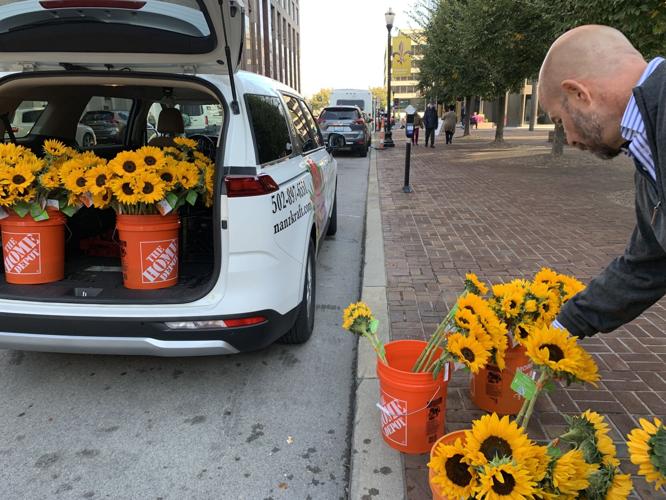 Local florist gives sunflowers away for free to brighten people's day