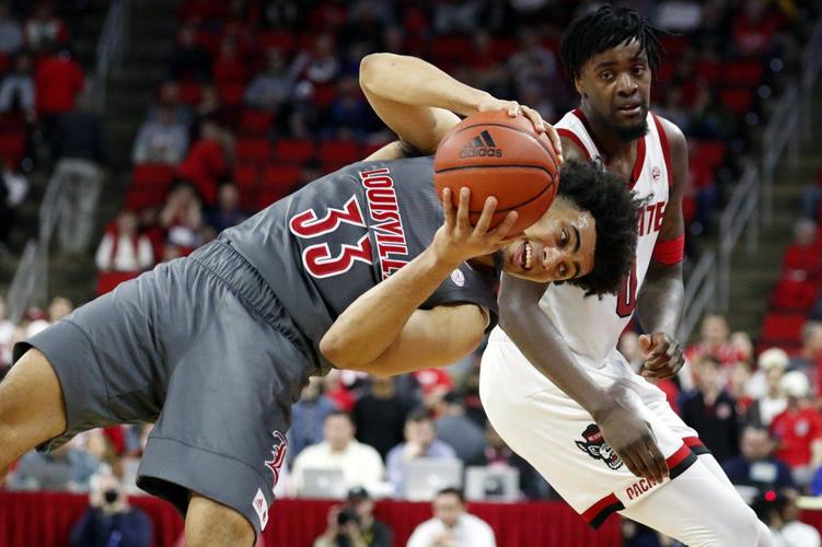 Louisville's Jordan Nwora (33) tries to stay in bounds
