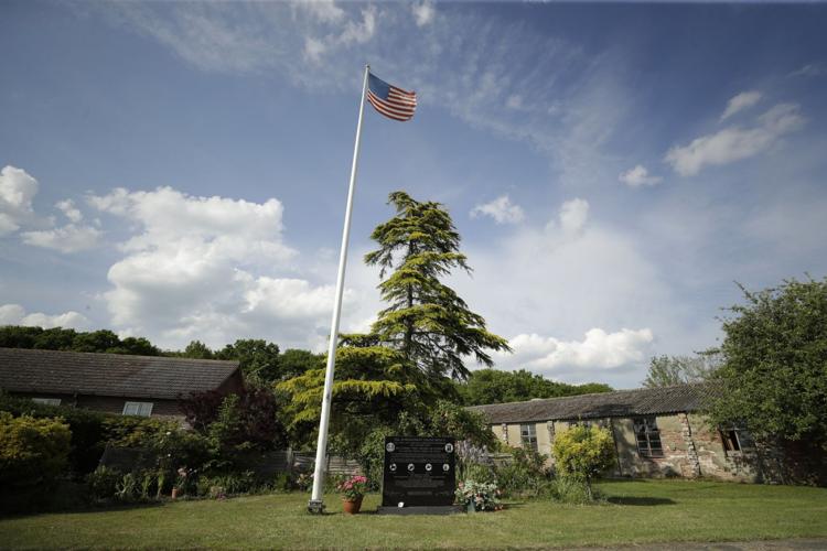 An American flag flies above a memorial for the American 93 Bombardment Group