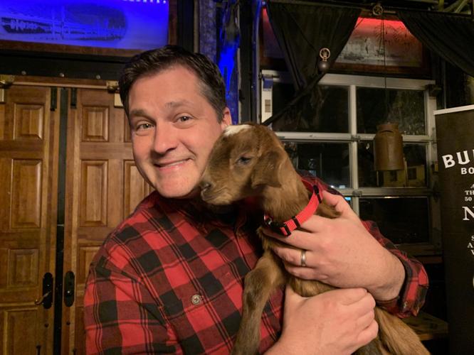 Keith Kaiser hugs a Bockfest goat