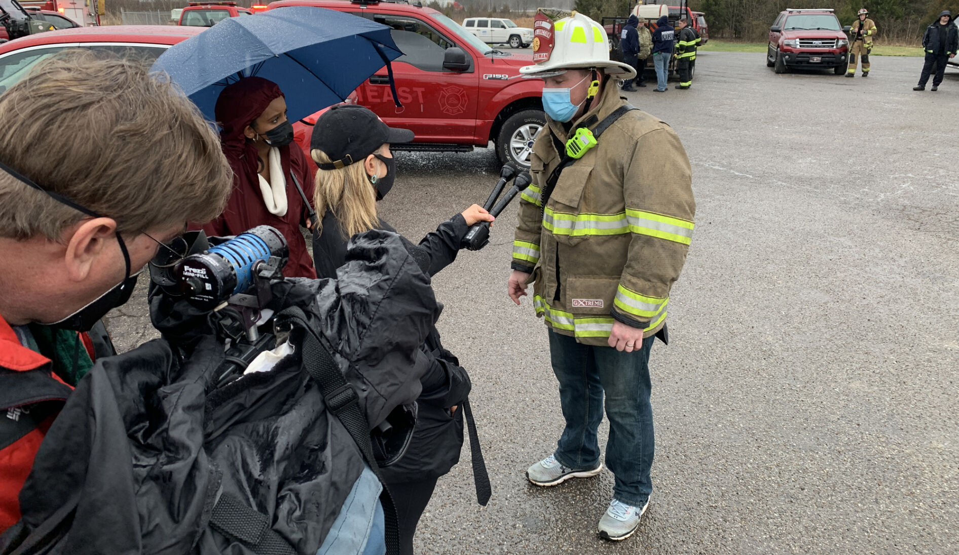 Joshua Coleman, chief of the Lebanon Junction Fire Department, talks to news crews