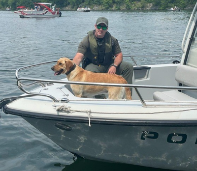 Conservation Officer Evan Hughes and K-9 Cosmo