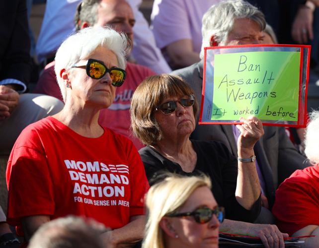 Woman holds up anti-gun sign during vigil.JPG