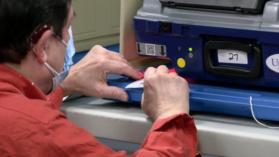 Technician works on ballot scanner at Prosser Career Center in New Albany