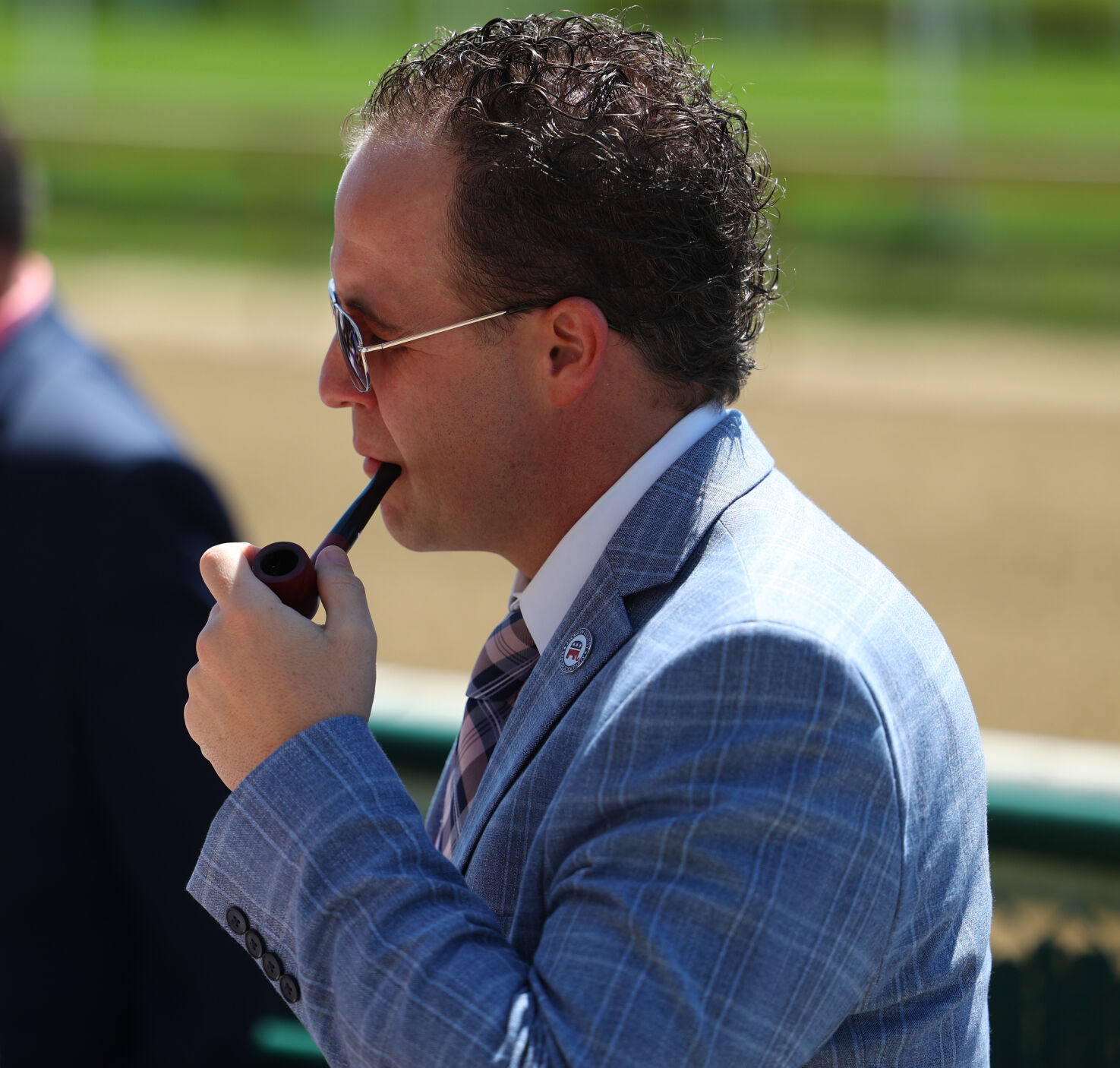 Man smokes pipe at Churchill Downs.JPG