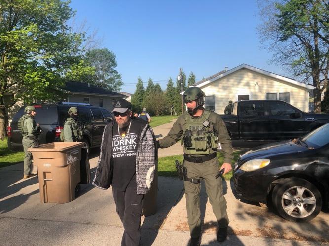 Jeremy Sweet escorted to patrol car.jpg