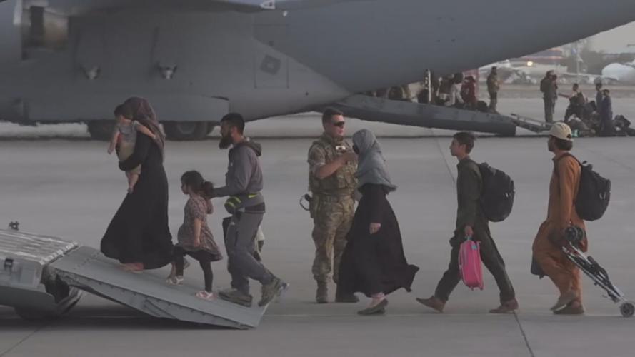 Afghan refugees board a US military aircraft in Kabul, Afghanistan