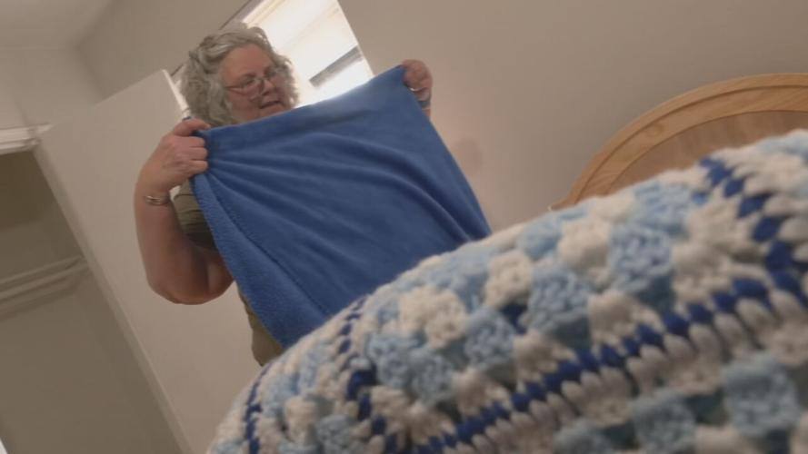 A volunteer with Catholic Charities prepares an apartment for refugees expected to arrive in Louisville