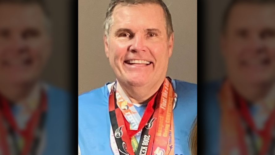 John Holland poses with miniMarathon medals