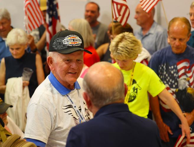 Vietnam veteran shakes a hand at Honor Flight Return Home.JPG
