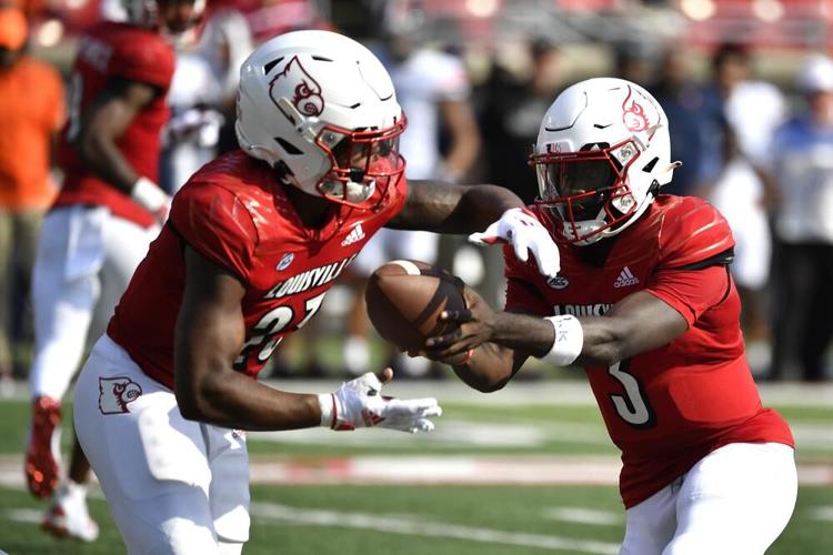 Trevion Cooley takes a handoff from Malik Cunningham.jpeg