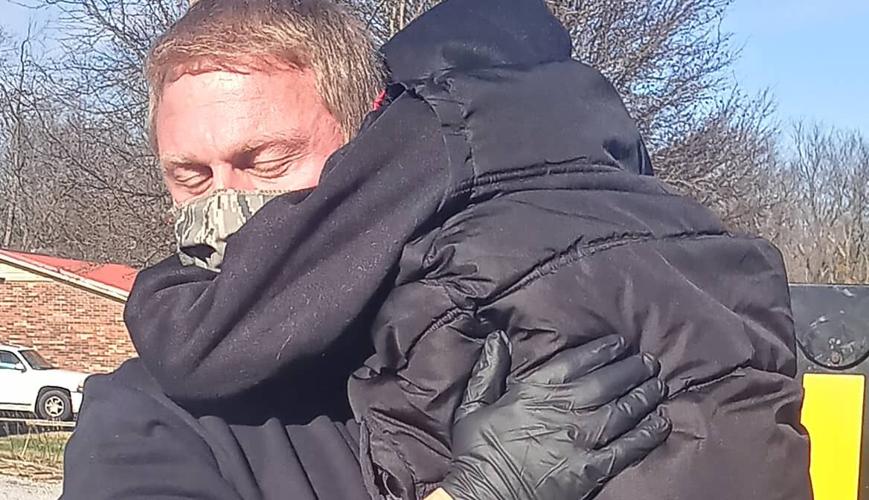 'DJ' hugs a firefighter from Shelbyville Fire & Rescue