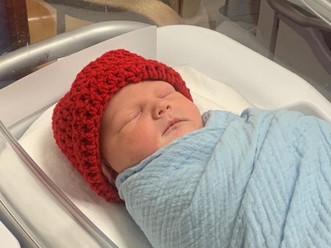 Baby in red hat for American Heart Month