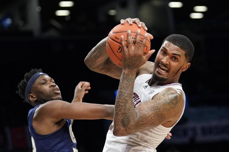 Louisville's Malik Williams rebounds against Georgia Tech's Jordan Meka.jpeg