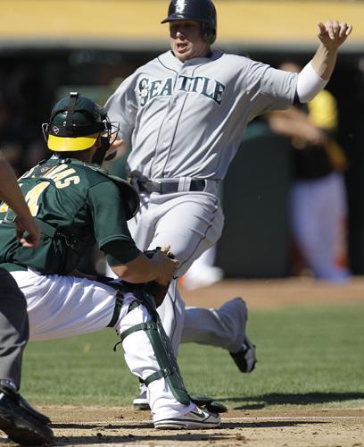 Oakland Athletics' Yoenis Cespedes, right, celebrates his solo home run  with teammate Josh Reddick (16) during the fourth inning of the second game  of a doubleheader baseball game against the Seattle Mariners