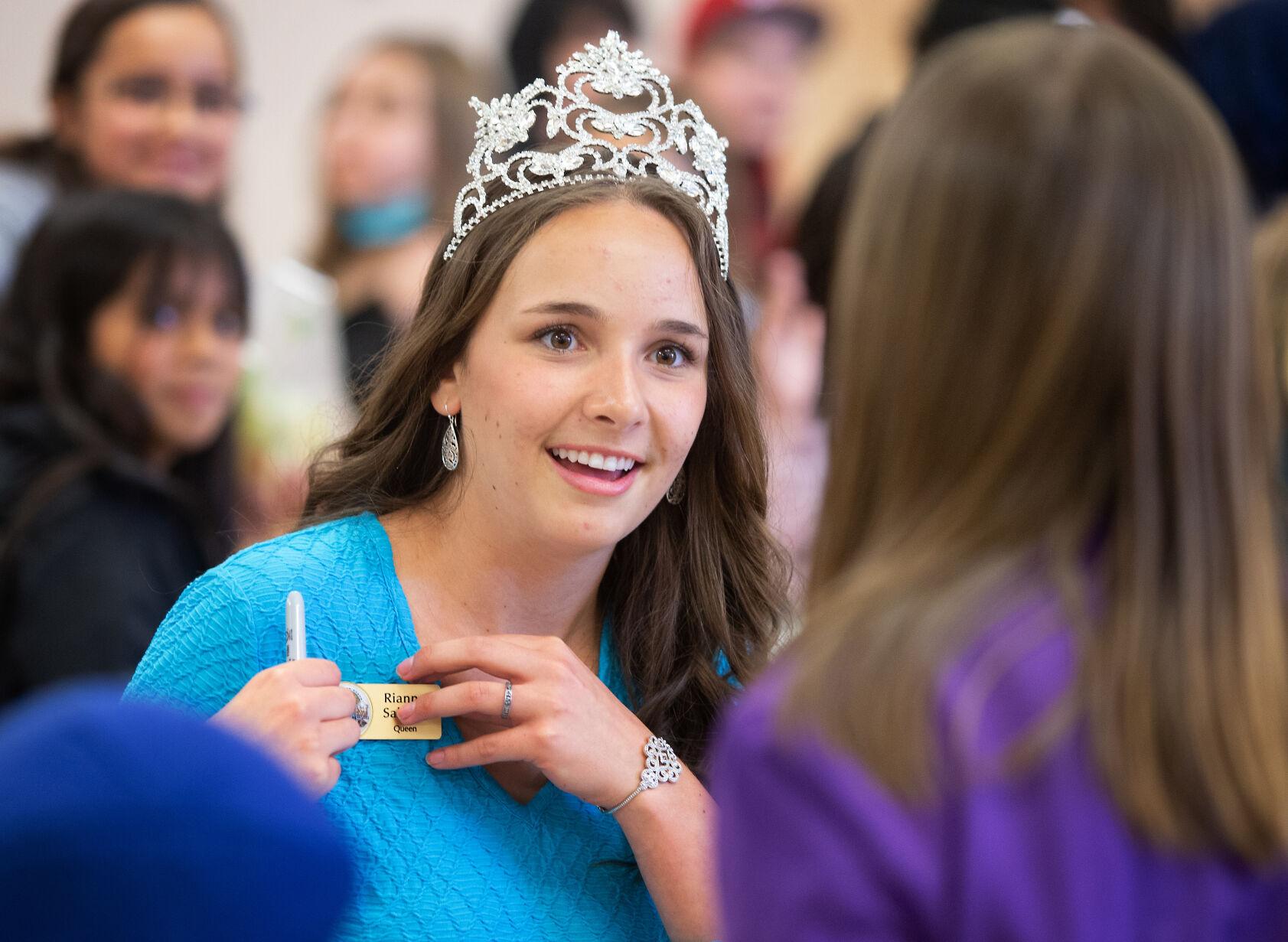 Apple Blossom Queen enjoys the moment while keeping an eye on the
