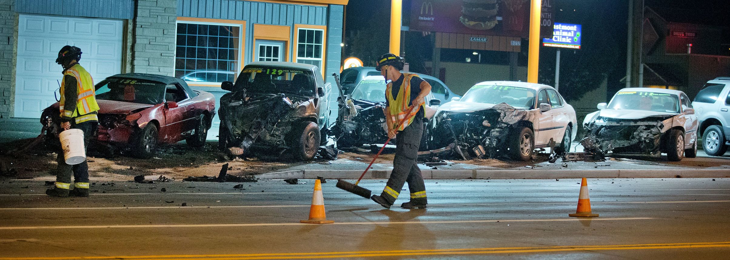 Speeding car crashes into five parked cars at highway intersection