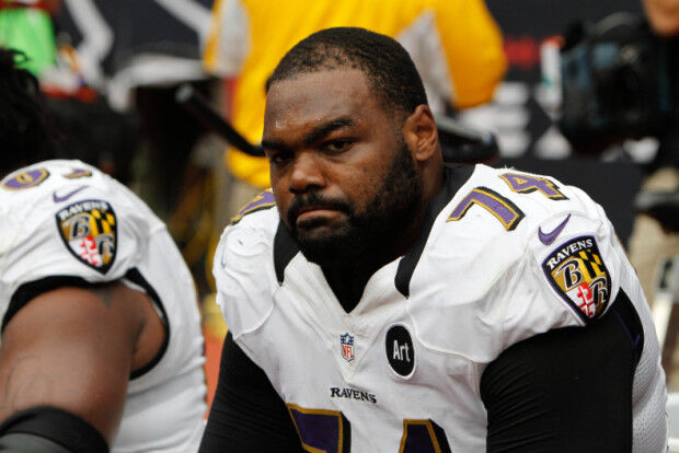 Michael Oher signs When Your Back's Against the Wall