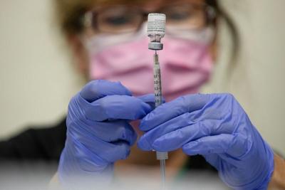 FILE PHOTO: People receive COVID-19 booster vaccination in Michigan