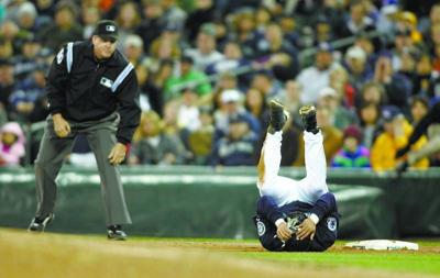 Texas Rangers' Jerry Hairston Jr., reacts to sliding in hard and