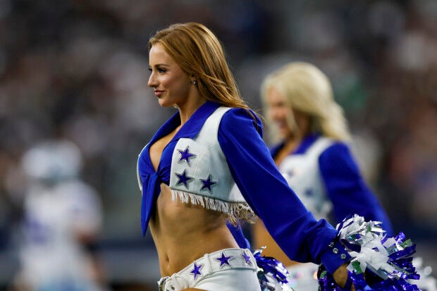 The Dallas Cowboys Cheerleaders perform during the game between the News  Photo - Getty Images