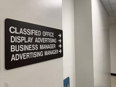 A sign directing toward Western Herald advertising offices in Faunce Student Services.
