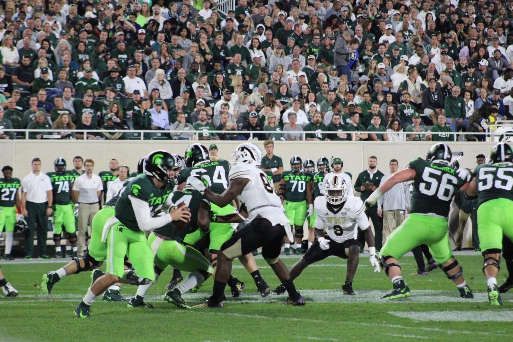 Michigan State's Brian Lewerke scrambles outside of the pocket
