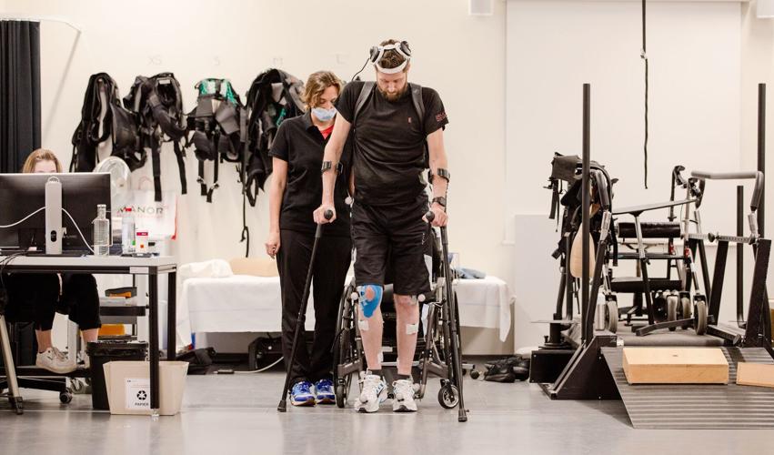 Man with paralysis walks naturally after brain, spine implants