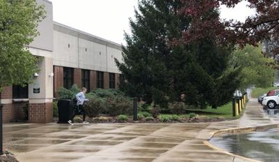Woman runs through the rain on Ivy Tech's campus during Primary Elections