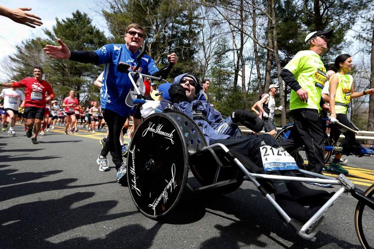 Rick Hoyt, whose late father pushed him through decades of Boston Marathons and other races, has died at 61