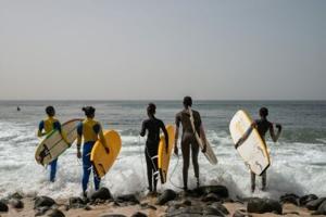 In Dakar fishing village, surfing entices girls back to school