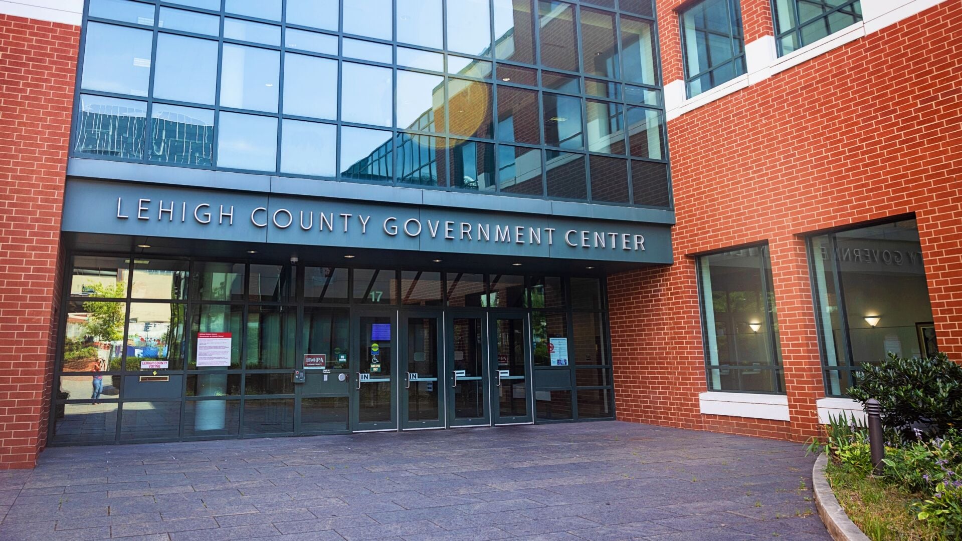 Front entrance of the Lehigh County Government Center, a brick and glass building in Allentown