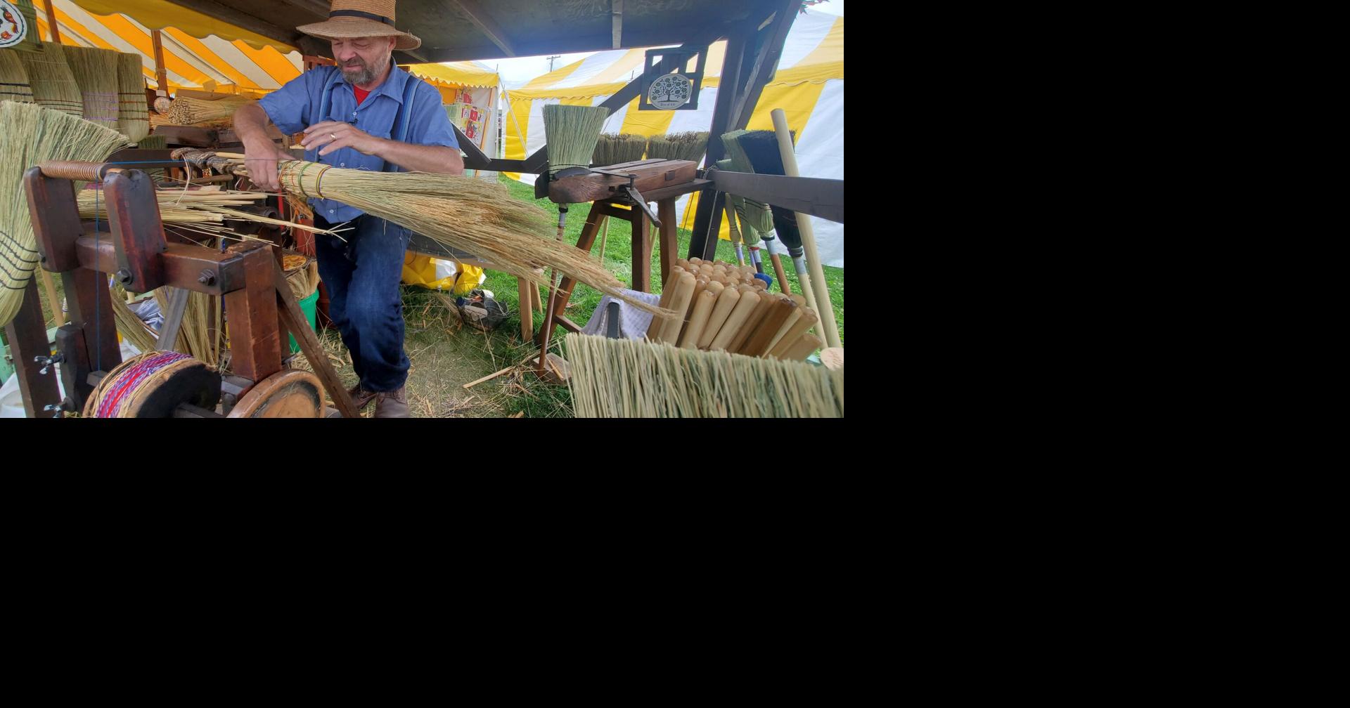 Handmade broom vendor sweeping up at Kutztown Folk Festival Berks