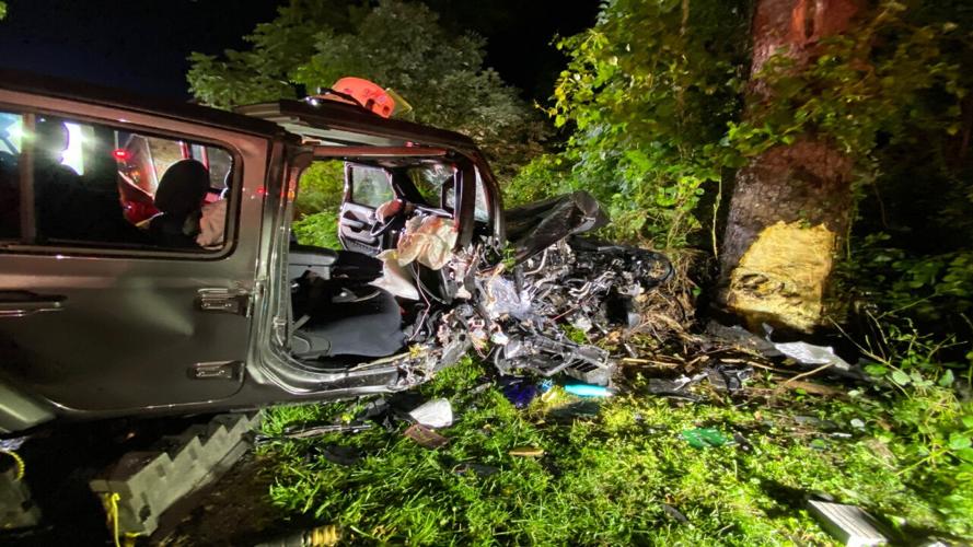 Emergency crews rescue person trapped inside heavily damaged vehicle