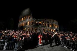 Pope leads torch-lit Colosseum procession before Easter