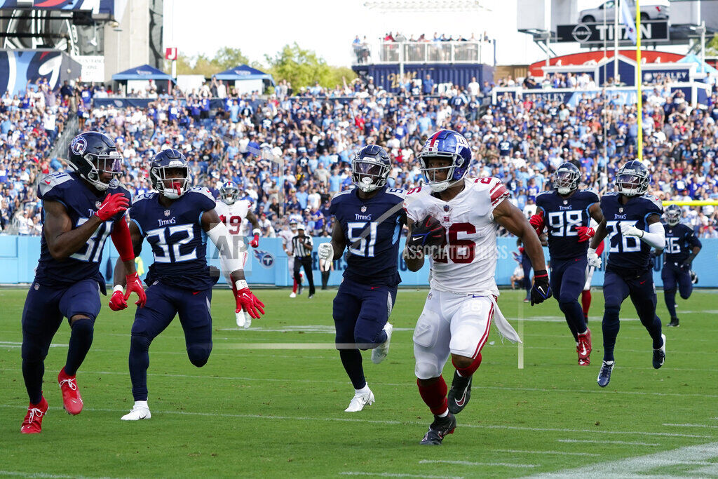 New York Giants running back Saquon Barkley (26) celebrates after making a  touchdown run against the Tennessee Titans during the second half of an NFL  football game Sunday, Sept. 11, 2022, in