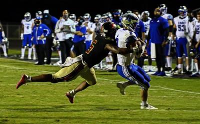 Junior Colson tacklin JJ McCarthy at Ravenwood